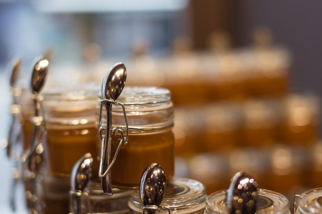 Caramel, a product of caramelization in glass jars.