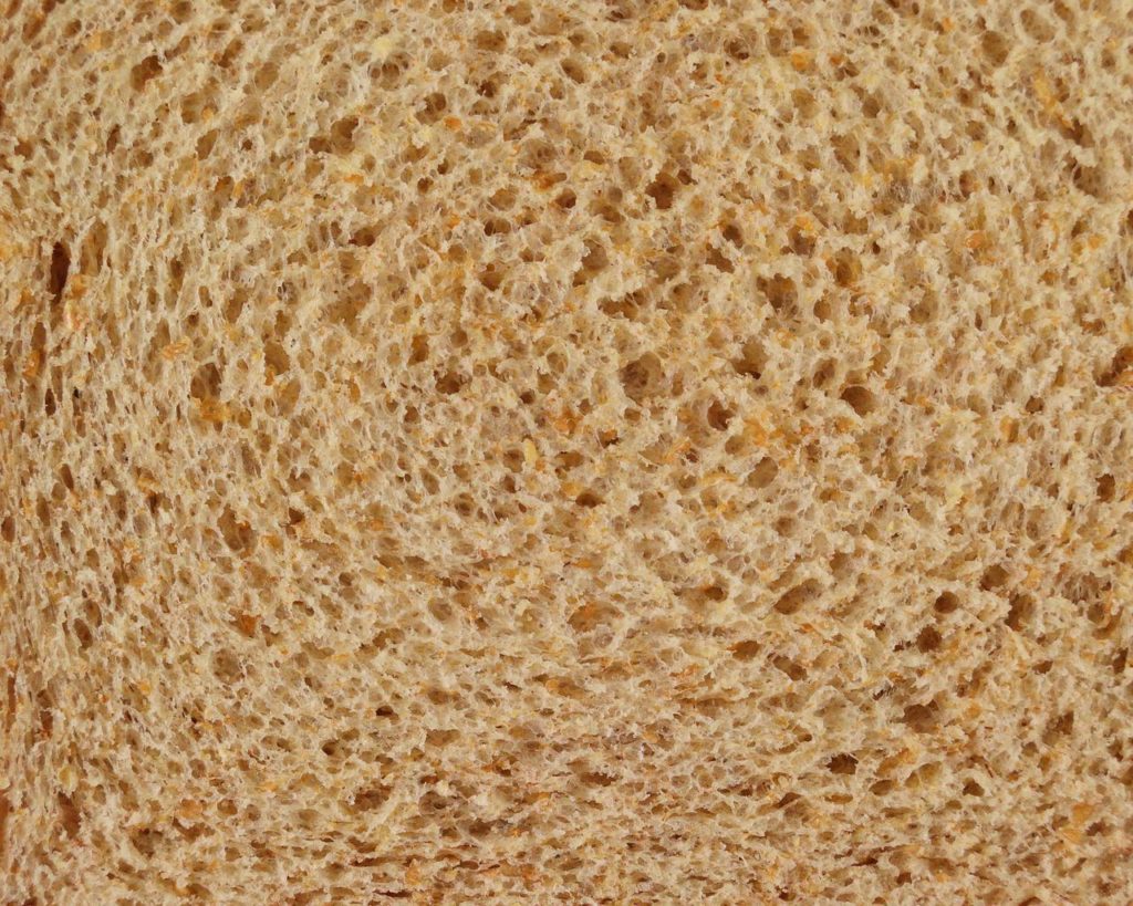 The holes in bread is caused by carbon dioxide trapped in the dough